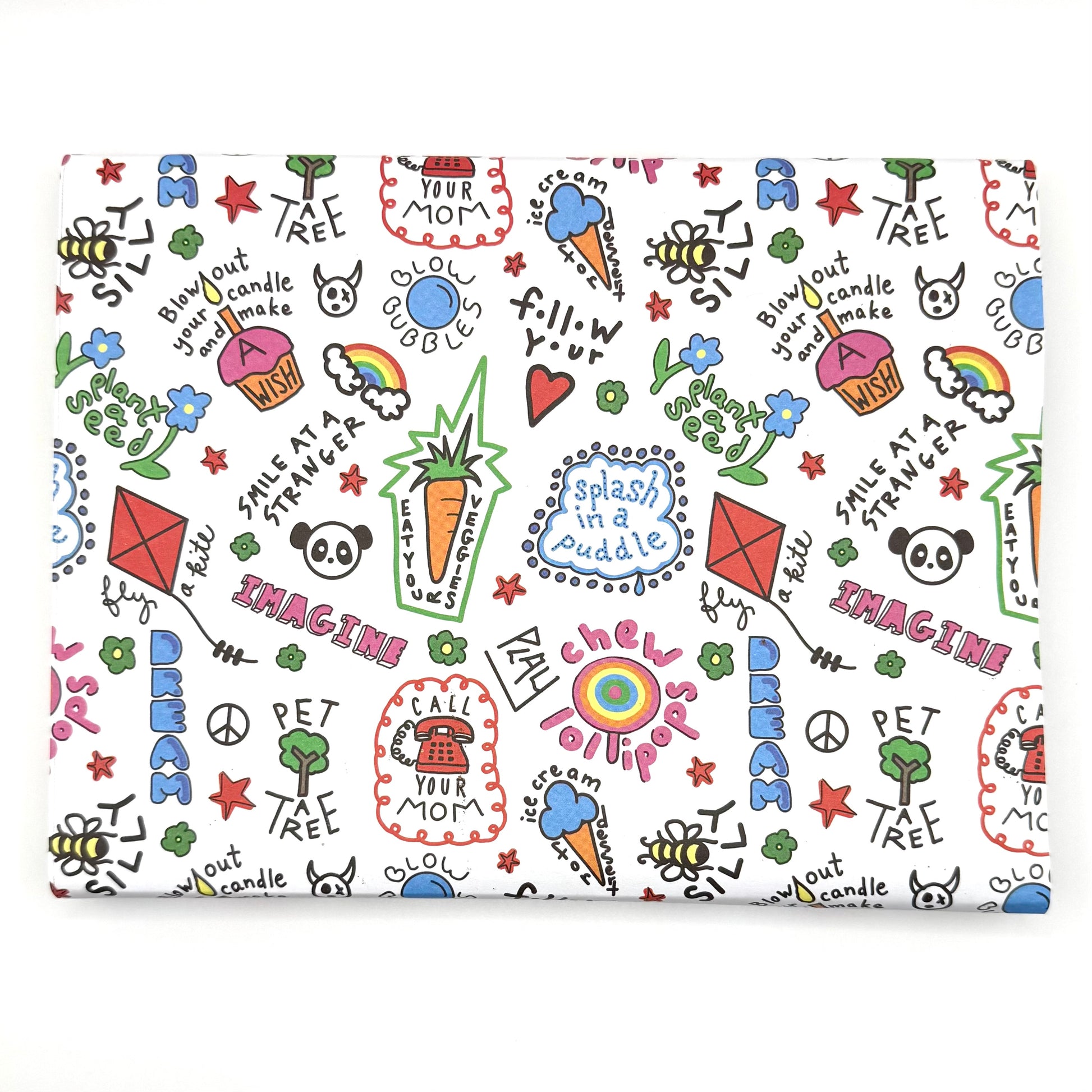 A sheet of wrapping paper with a colorful and playful design featuring text, stars, hearts, and other playful graphics.