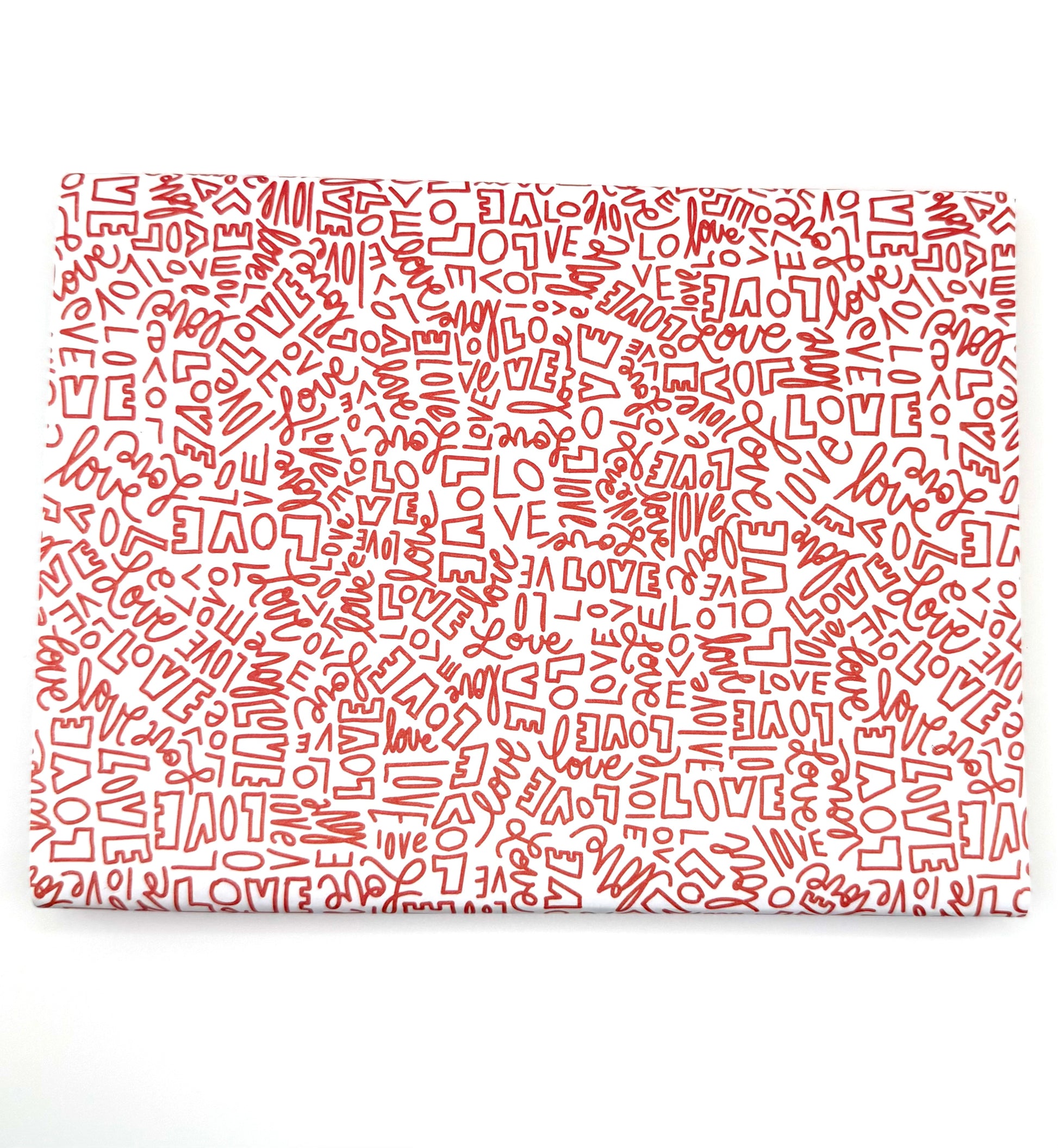 Wrapping paper with a repeating red pattern of the word "LOVE" in various fonts and sizes.