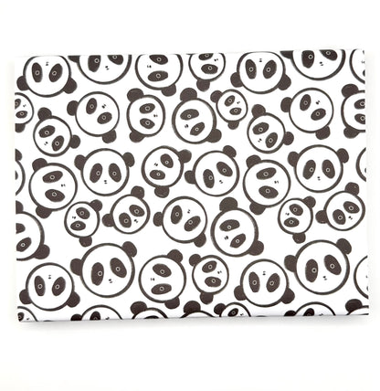 Wrapping paper with a repeating pattern of black-and-white panda faces faces.