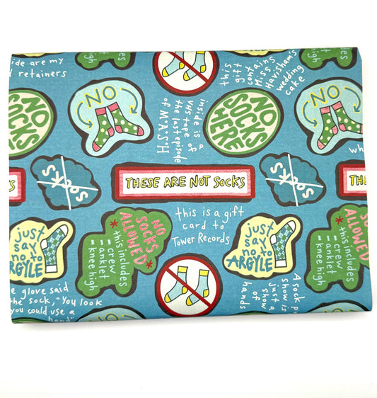 Blue wrapping paper with colorful sock graphics and humorous text like "not socks"